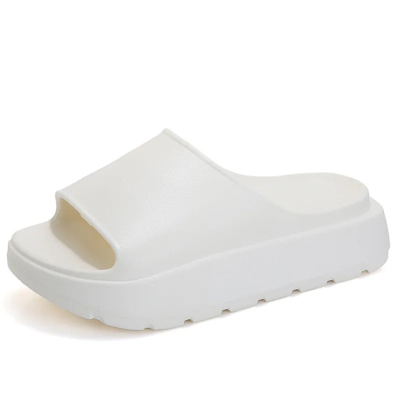 A pair of stylish Soft Thick Sole Slides in a modern design, made from soft EVA material, perfect for summer outings.
