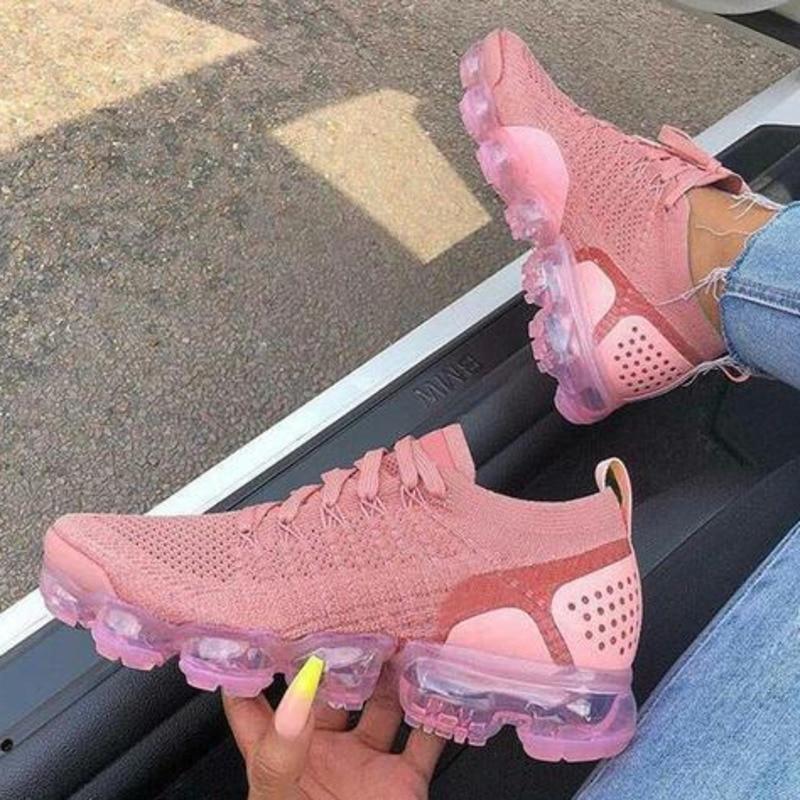 A pair of Women's Flying Woven Breathable Casual Sneakers in vibrant pink, showcasing a stylish and breathable design perfect for casual wear.