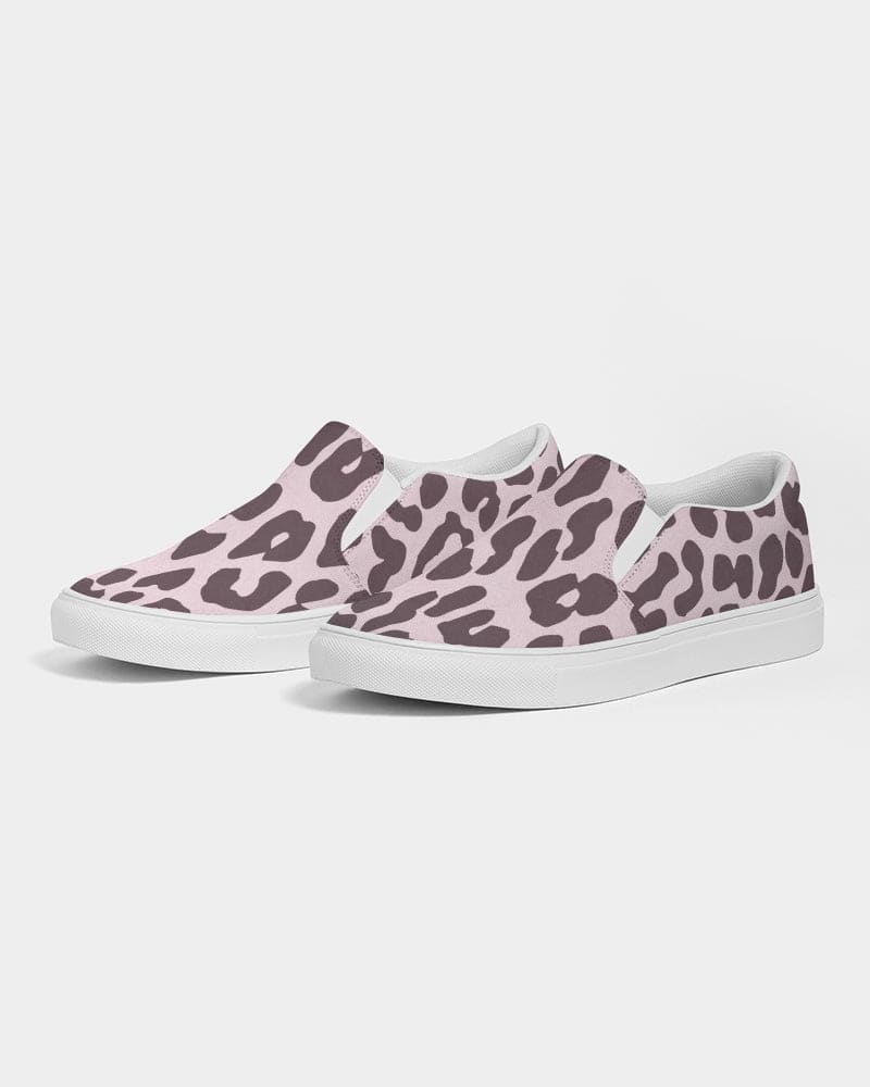 A pair of women's canvas slip-on sneakers featuring a vibrant pink leopard print design, perfect for casual wear.