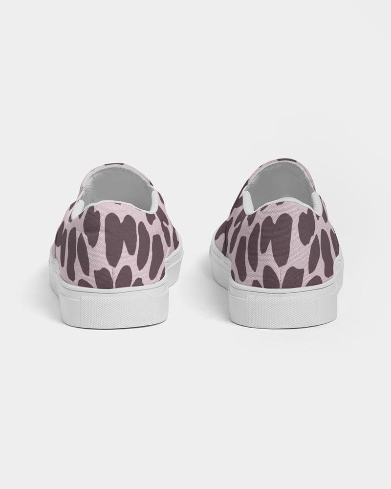 A pair of women's canvas slip-on sneakers featuring a vibrant pink leopard print design, perfect for casual wear.