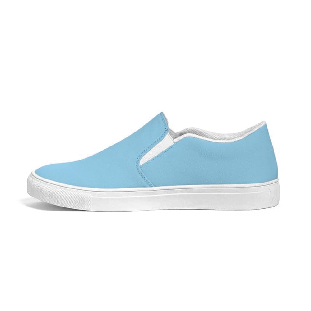 A pair of women's light blue low top slip-on canvas sneakers with elastic side accents and a padded collar, perfect for casual wear.