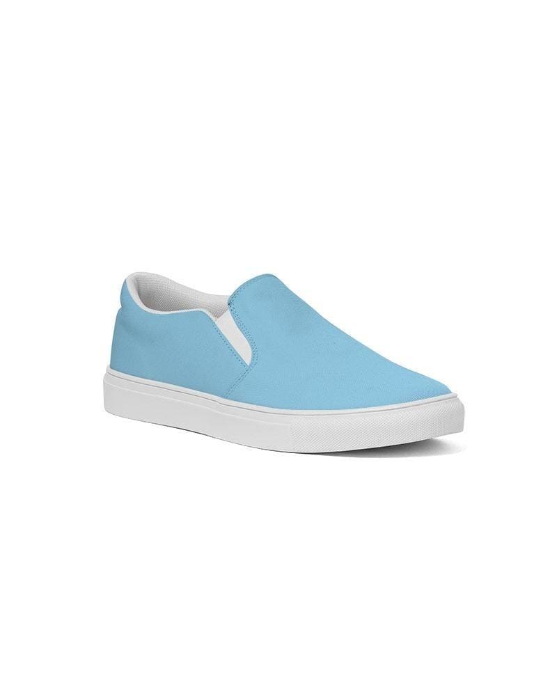 A pair of women's light blue low top slip-on canvas sneakers with elastic side accents and a padded collar, perfect for casual wear.