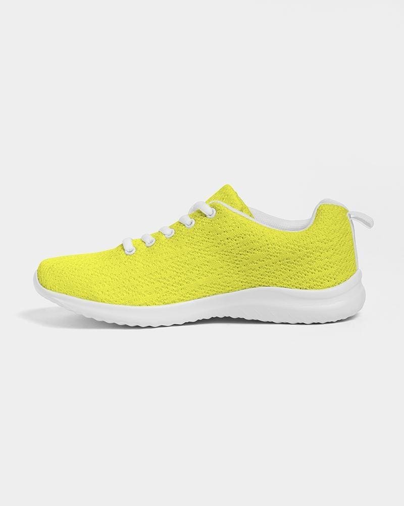 A pair of vibrant yellow canvas women's sneakers with a lace-up front, padded collar, and breathable lining, perfect for sports and running.
