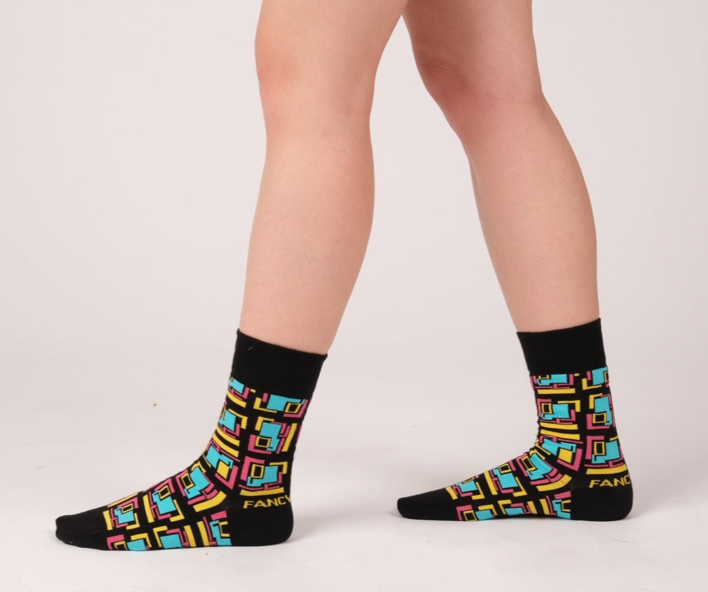 A pair of stylish black and purple geometric socks, showcasing a modern design perfect for any outfit.