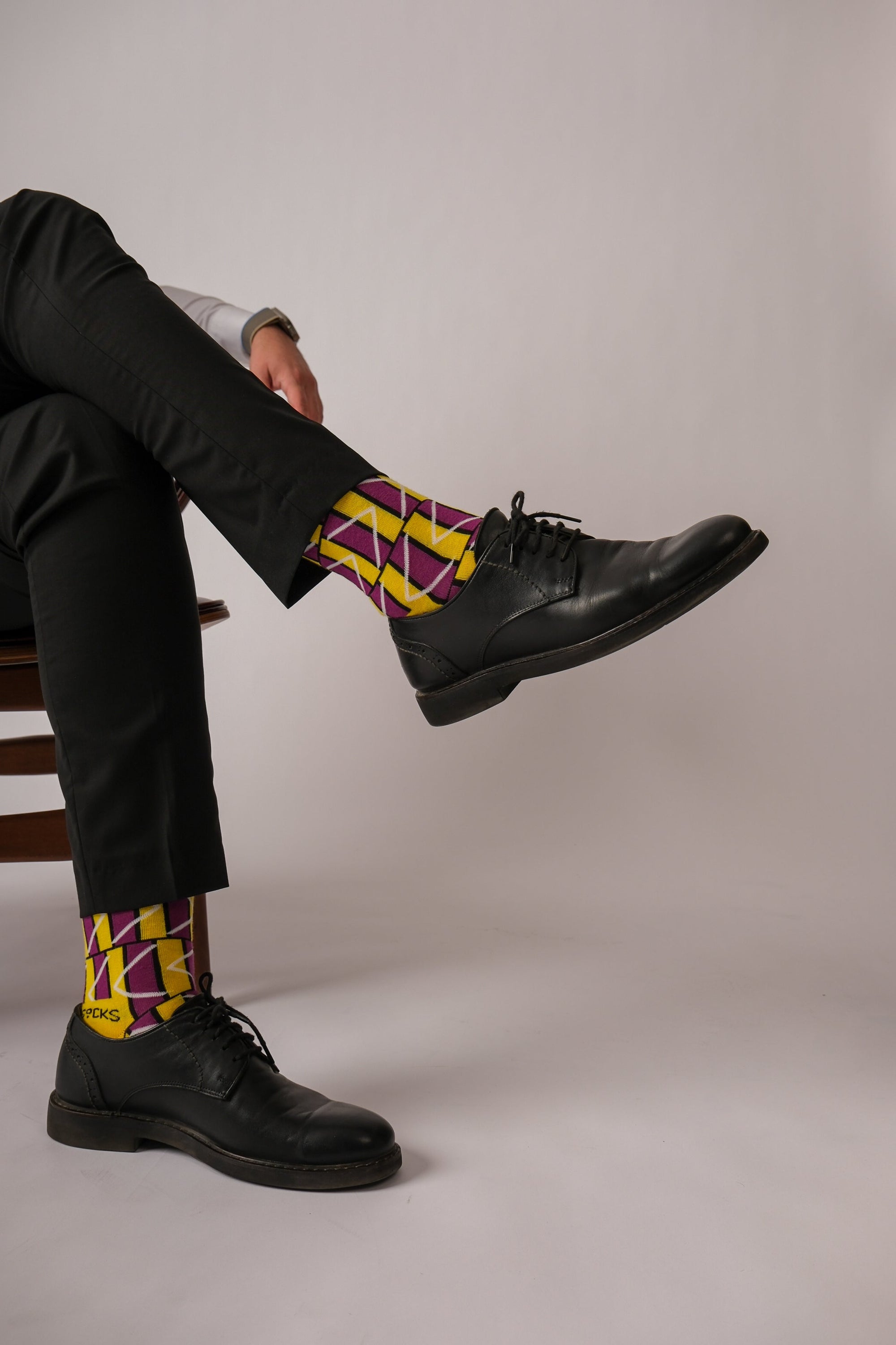 A pair of stylish black and purple geometric socks, showcasing a modern design perfect for any outfit.