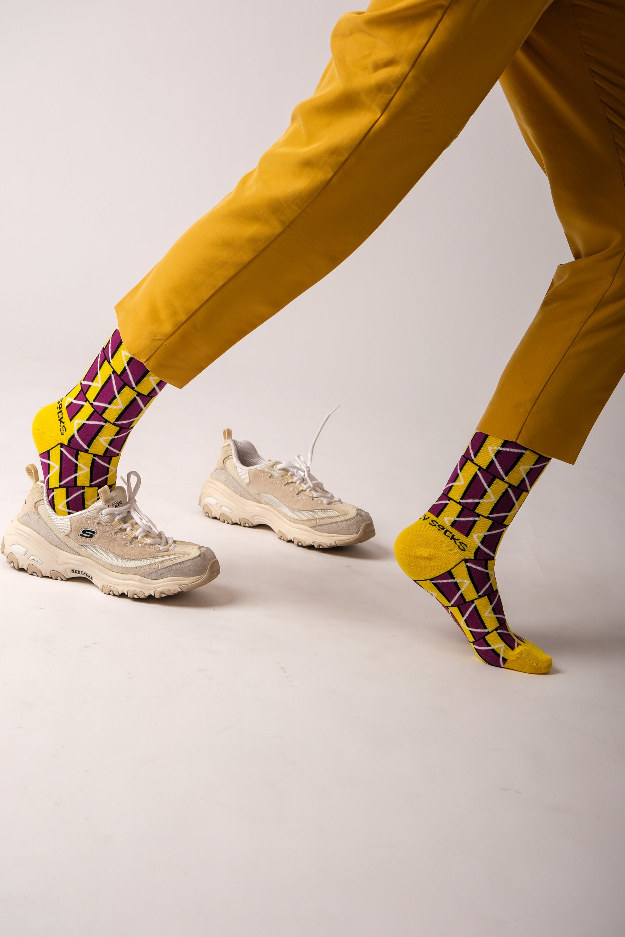 A pair of stylish black and purple geometric socks, showcasing a modern design perfect for any outfit.