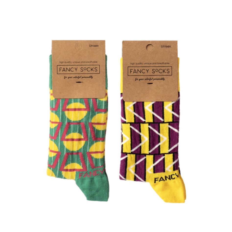A pair of stylish green and purple geometric socks displayed together, showcasing their vibrant colors and unique patterns.