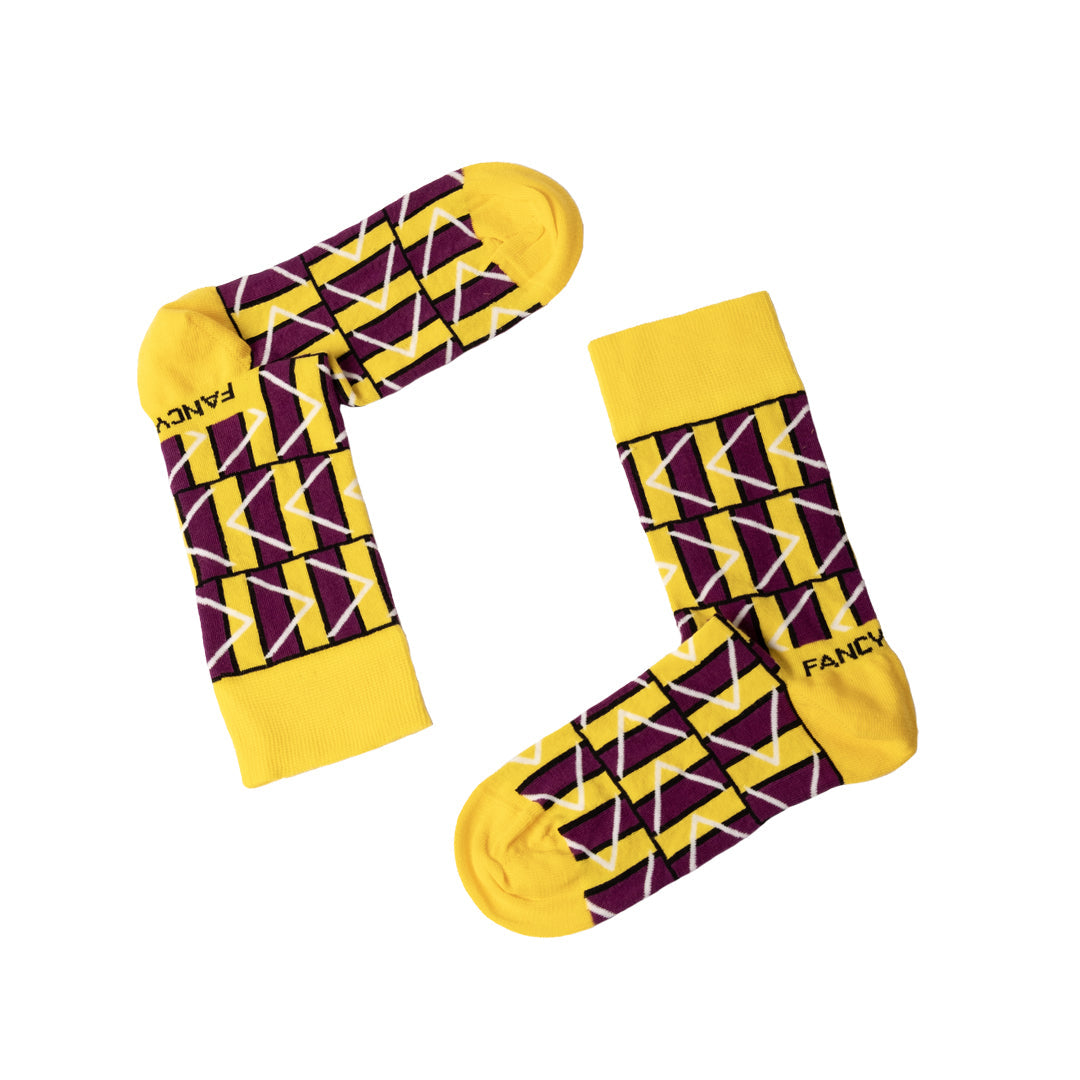 A pair of vibrant yellow and purple geometric socks, showcasing a stylish design perfect for any outfit.