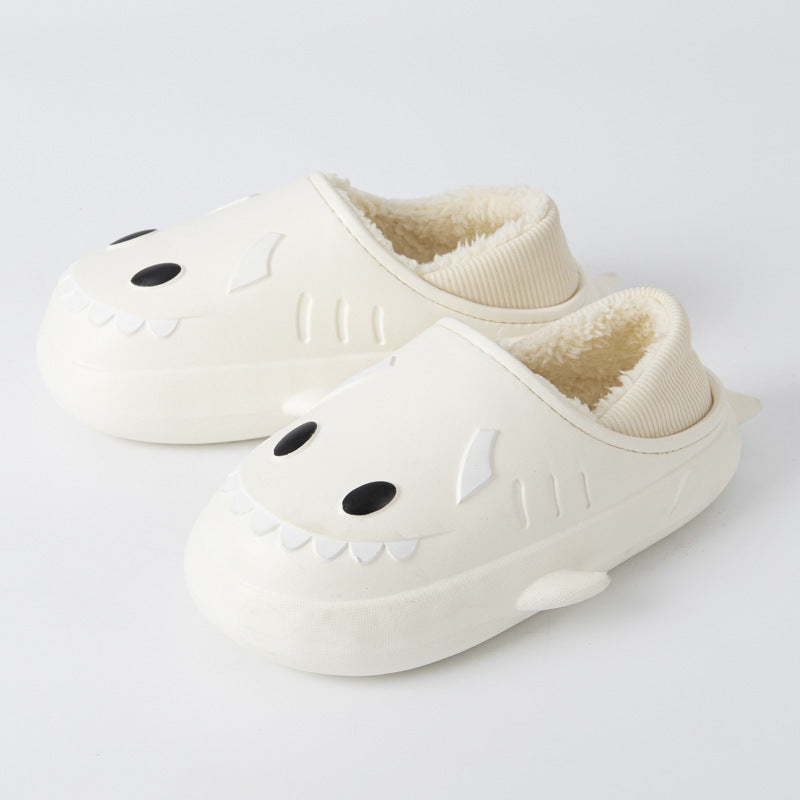 Cute women's waterproof shark cotton slippers in a cozy indoor setting, showcasing their playful design and soft material.