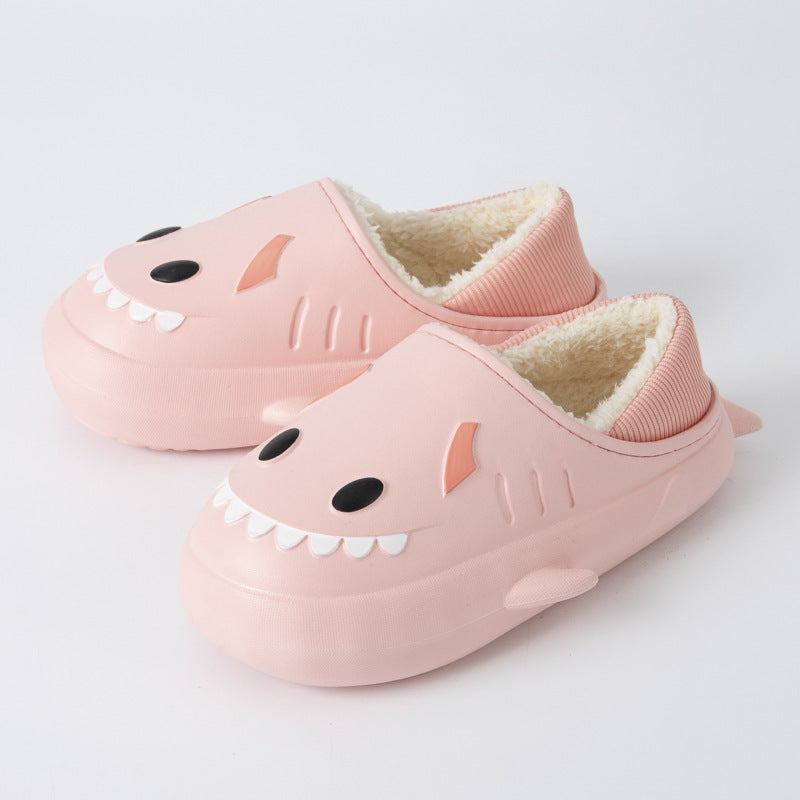 Cute women's waterproof shark cotton slippers in a cozy indoor setting, showcasing their playful design and soft material.