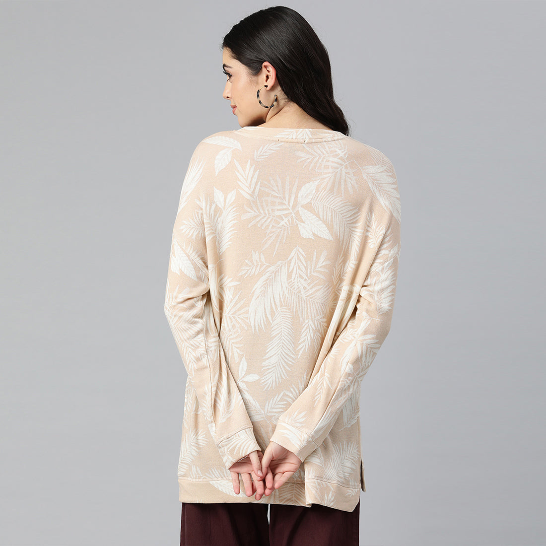 Beige oversized fleece tunic with crew neckline and drop shoulders, featuring an all-over printed design.