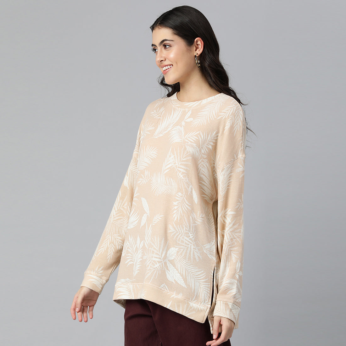 Beige oversized fleece tunic with crew neckline and drop shoulders, featuring an all-over printed design.