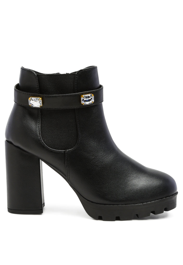 Stylish black ankle strap Chelsea boots with chunky diamante and side zipper, featuring block heels and rugged sole.