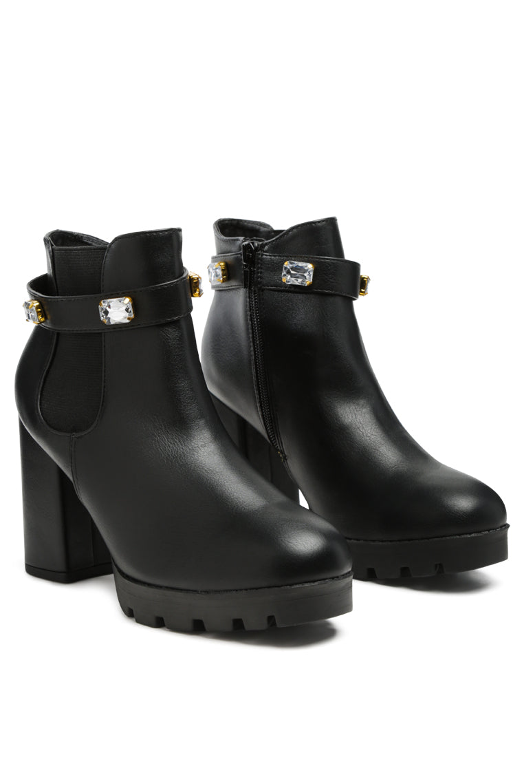 Stylish black ankle strap Chelsea boots with chunky diamante and side zipper, featuring block heels and rugged sole.