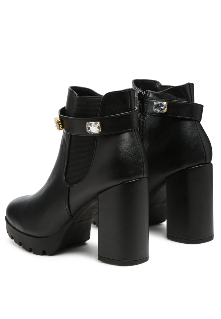 Stylish black ankle strap Chelsea boots with chunky diamante and side zipper, featuring block heels and rugged sole.