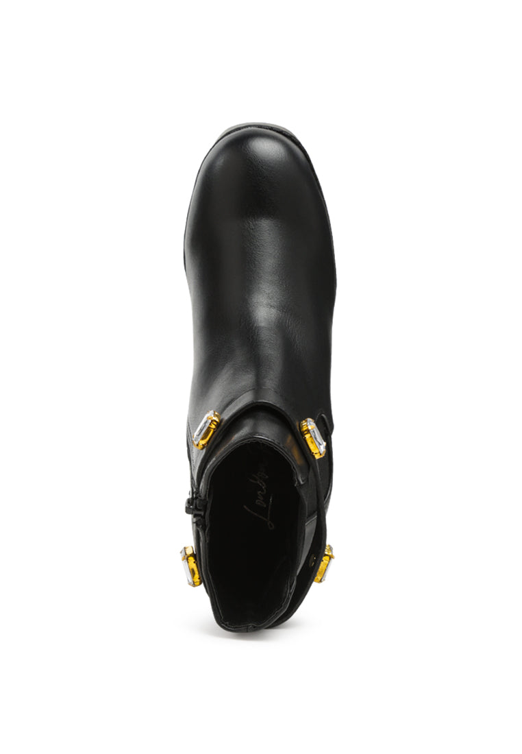 Stylish black ankle strap Chelsea boots with chunky diamante and side zipper, featuring block heels and rugged sole.