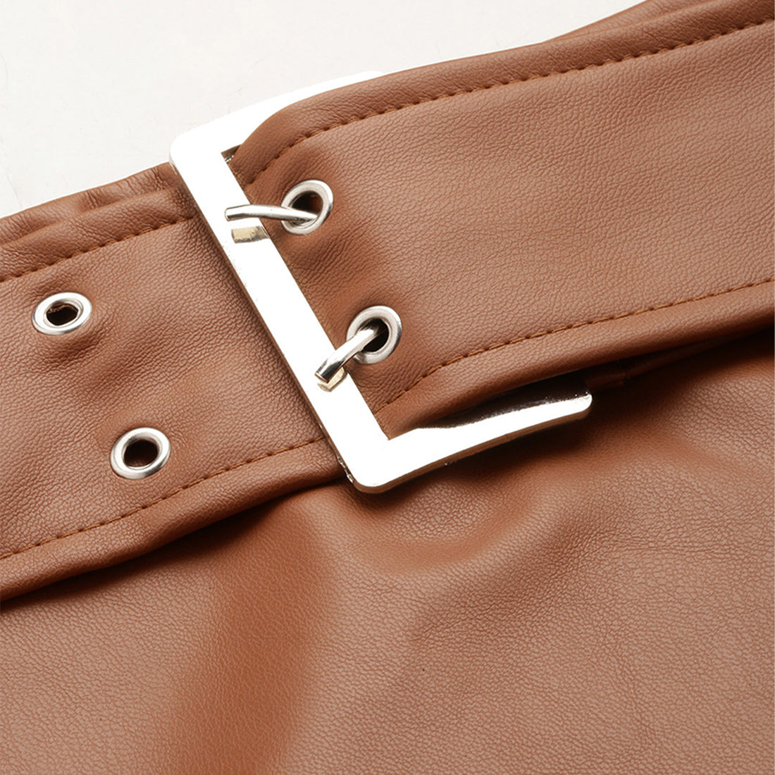 A stylish Bodycon Mini Slit Skirt featuring buckle details, showcasing its sleek design and soft fabric.