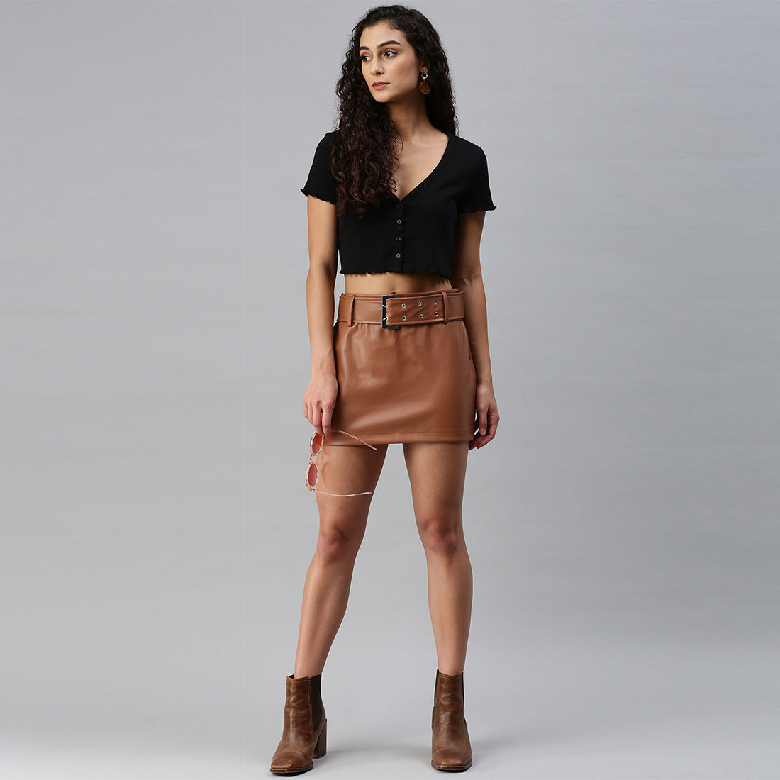 A stylish Bodycon Mini Slit Skirt featuring buckle details, showcasing its sleek design and soft fabric.