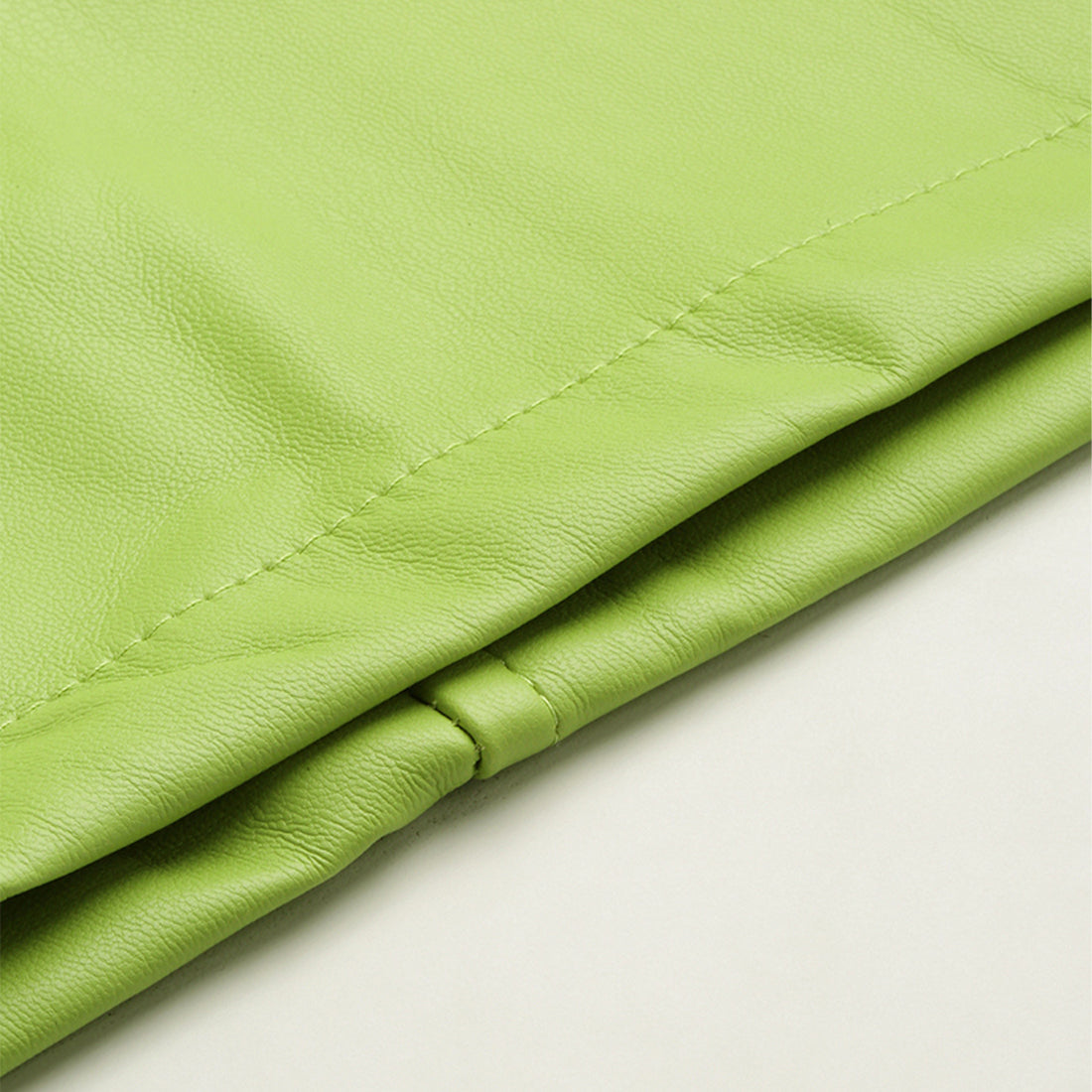 A stylish Bodycon Mini Slit Skirt featuring buckle details, showcasing its sleek design and soft fabric.