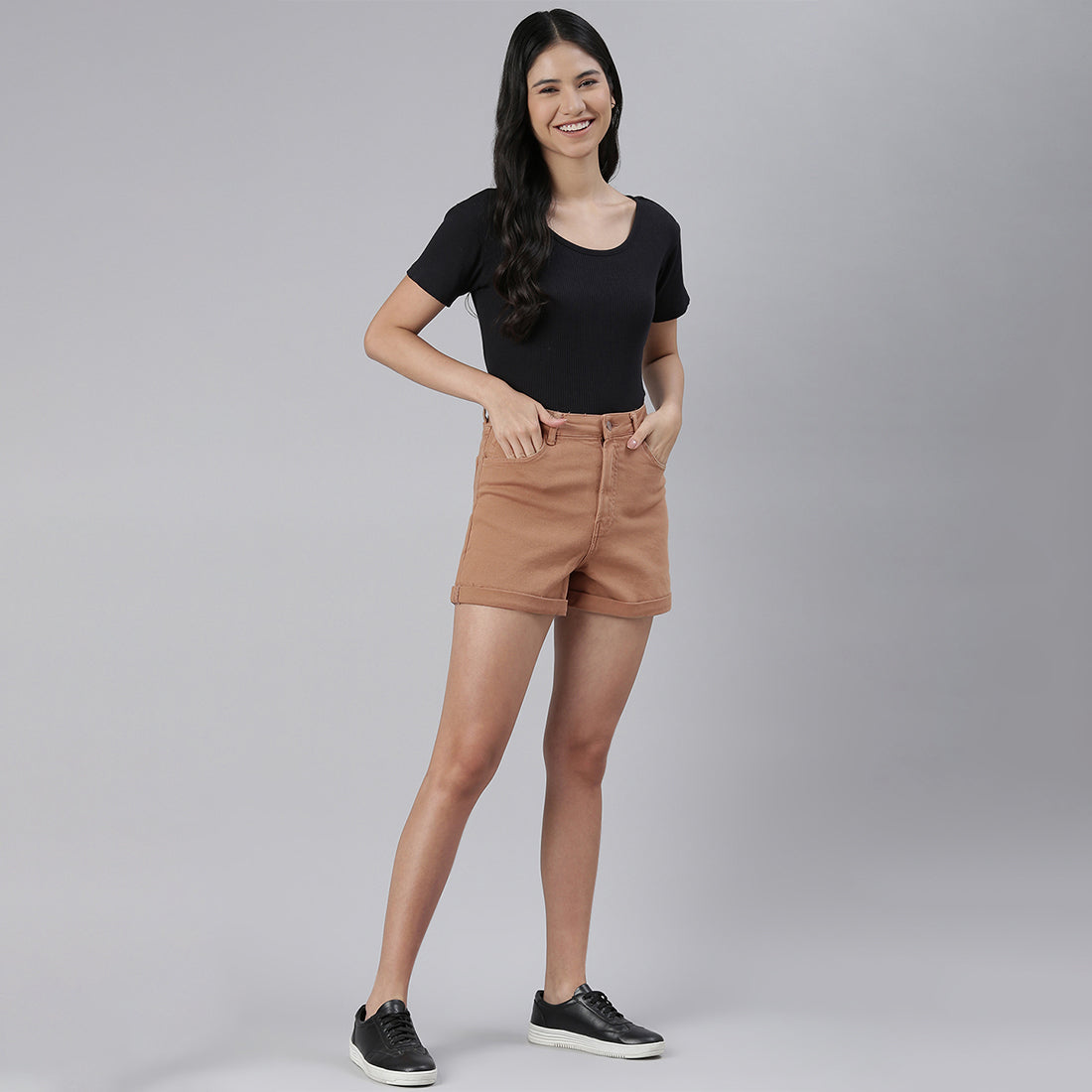 Camel high waist shorts with upturned hem and pockets, showcasing a stylish summer look.