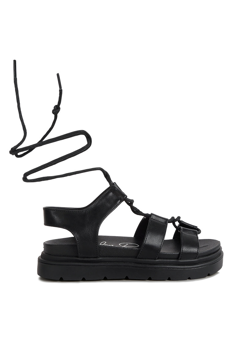 Dylan Strappy Gladiator Sandals featuring faux leather, lace-up detail, and open rounded toe design.