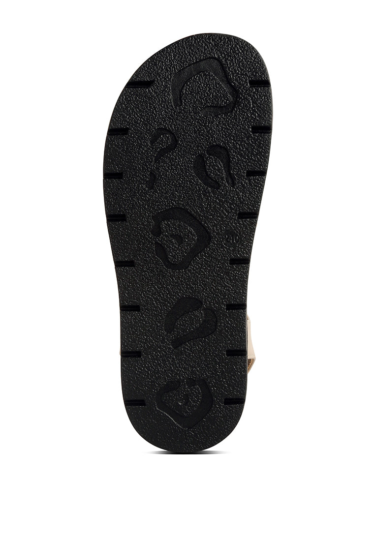 Dylan Strappy Gladiator Sandals featuring faux leather, lace-up detail, and open rounded toe design.