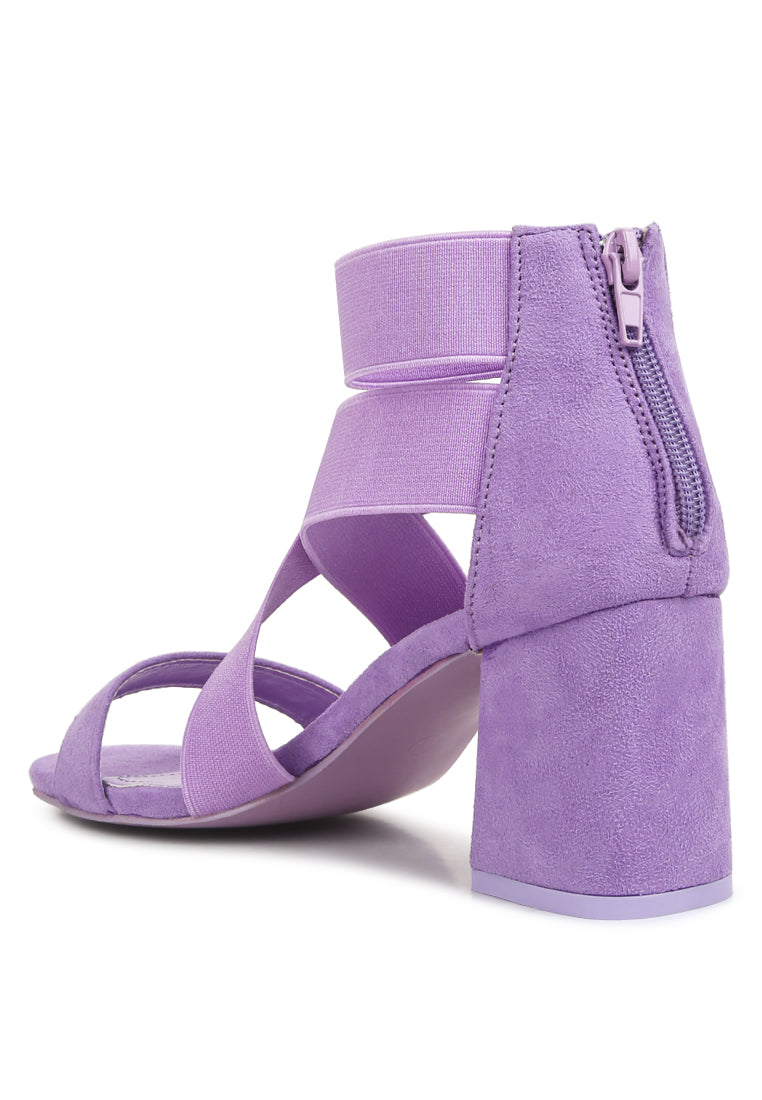 A pair of stylish Elastic Strappy Block Heel Sandals featuring elastic straps, padded insoles, and a back zipper for easy wear.