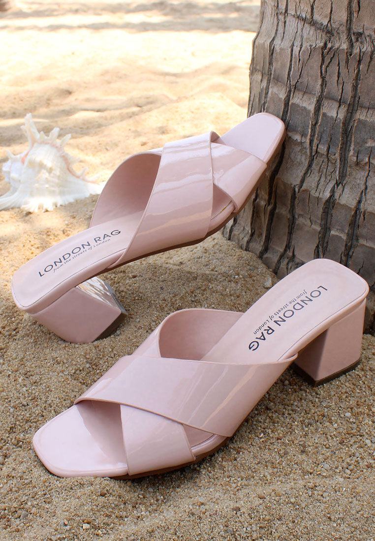 Emine Block Heeled Slip-On Sandals featuring a stylish block heel and open toe design, made from faux leather and faux suede.