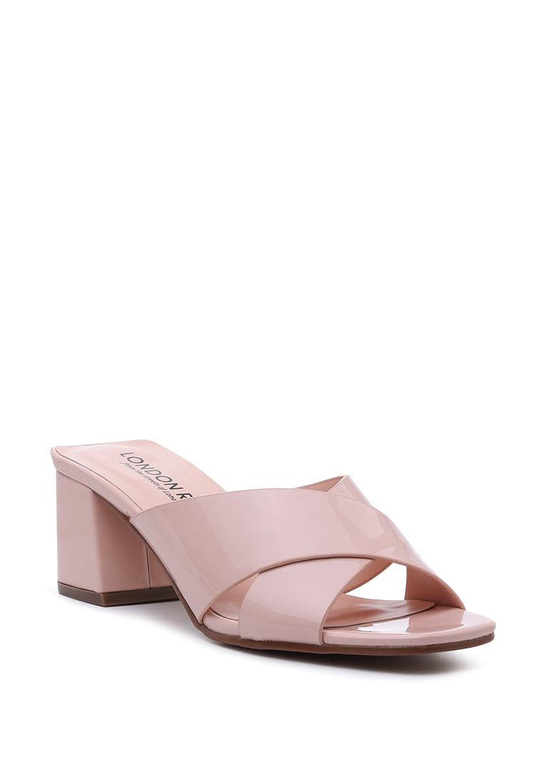 Emine Block Heeled Slip-On Sandals featuring a stylish block heel and open toe design, made from faux leather and faux suede.