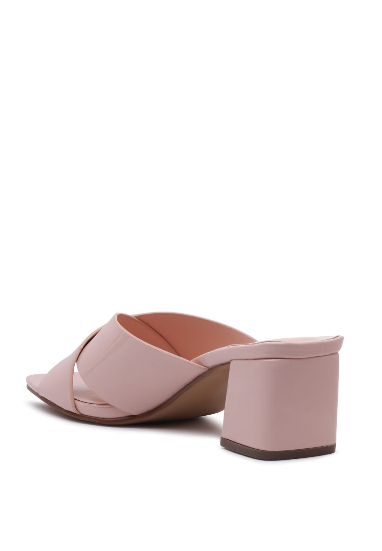 Emine Block Heeled Slip-On Sandals featuring a stylish block heel and open toe design, made from faux leather and faux suede.
