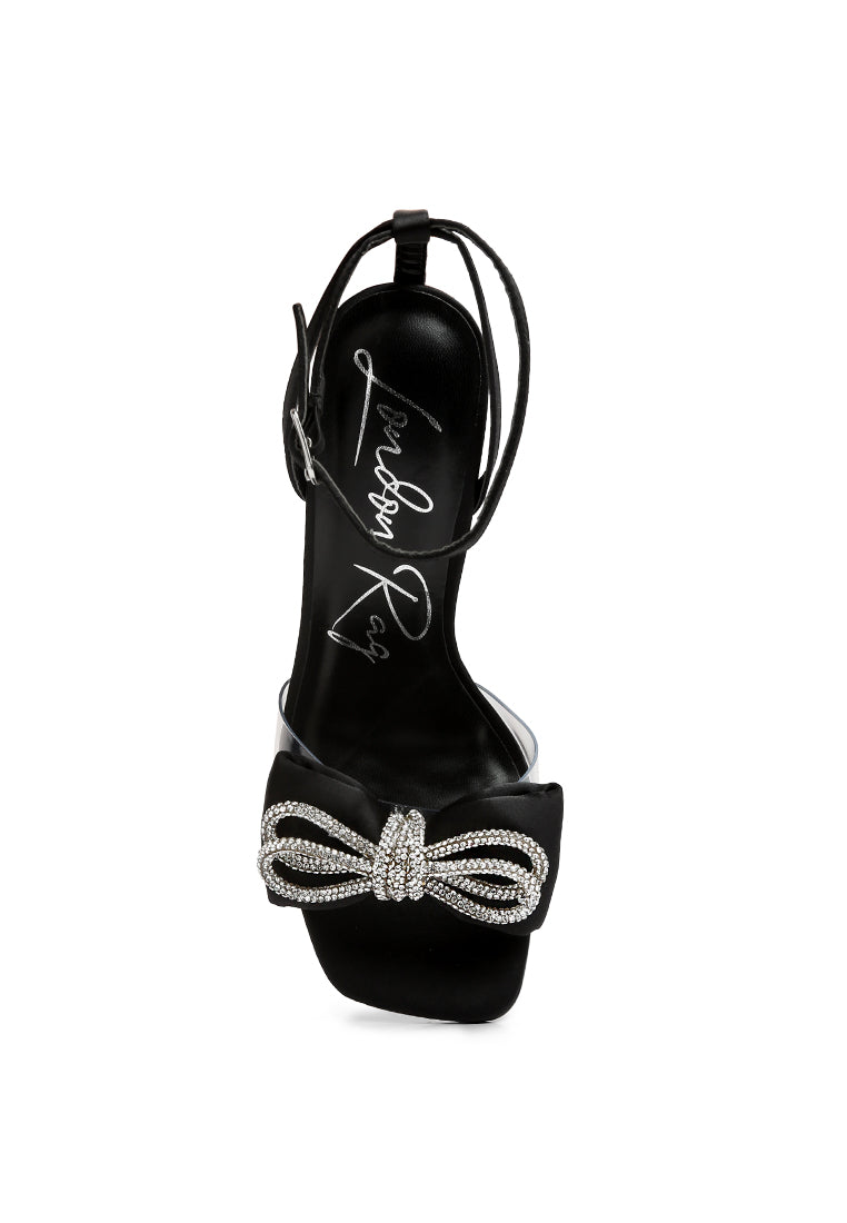 Elegant Etherium Bow Heeled Sandals with oversized bow and pin buckle fastening, crafted from satin with a durable TPR sole.