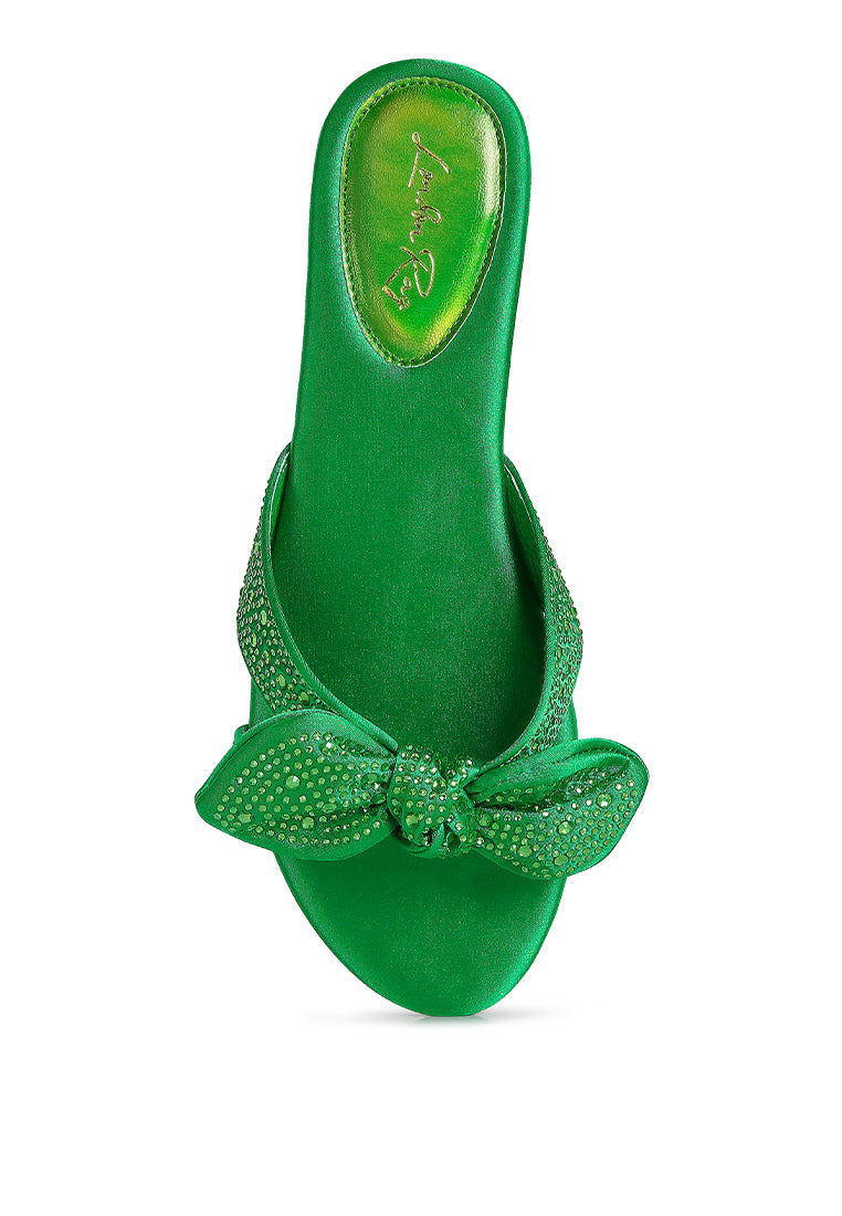 Fleurette Bow Flat Sandals featuring a satin upper, diamante bow, and flat heel design, perfect for elegant and comfortable wear.