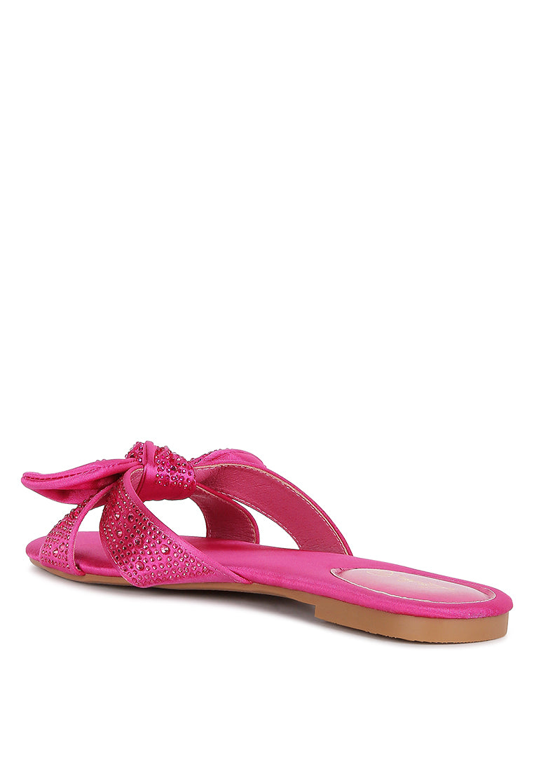 Fleurette Bow Flat Sandals featuring a satin upper, diamante bow, and flat heel design, perfect for elegant and comfortable wear.