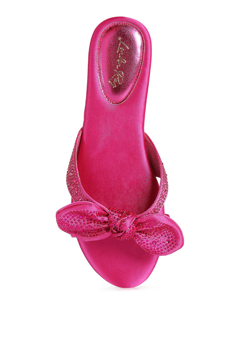 Fleurette Bow Flat Sandals featuring a satin upper, diamante bow, and flat heel design, perfect for elegant and comfortable wear.