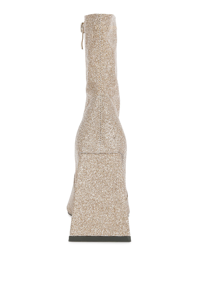 Hustlers Shimmer Block Heeled Ankle Boots featuring a shiny textile, block heels, and a side zipper for easy wear.