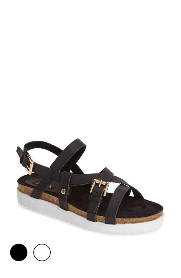 Stylish JAXON sandals made from vegan PU leather featuring strappy details and a padded footbed with a side buckle closure.