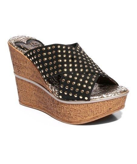 Stylish Manhattan studded wedges with a leather upper and cork wedge outsole, featuring a snake print sock liner.
