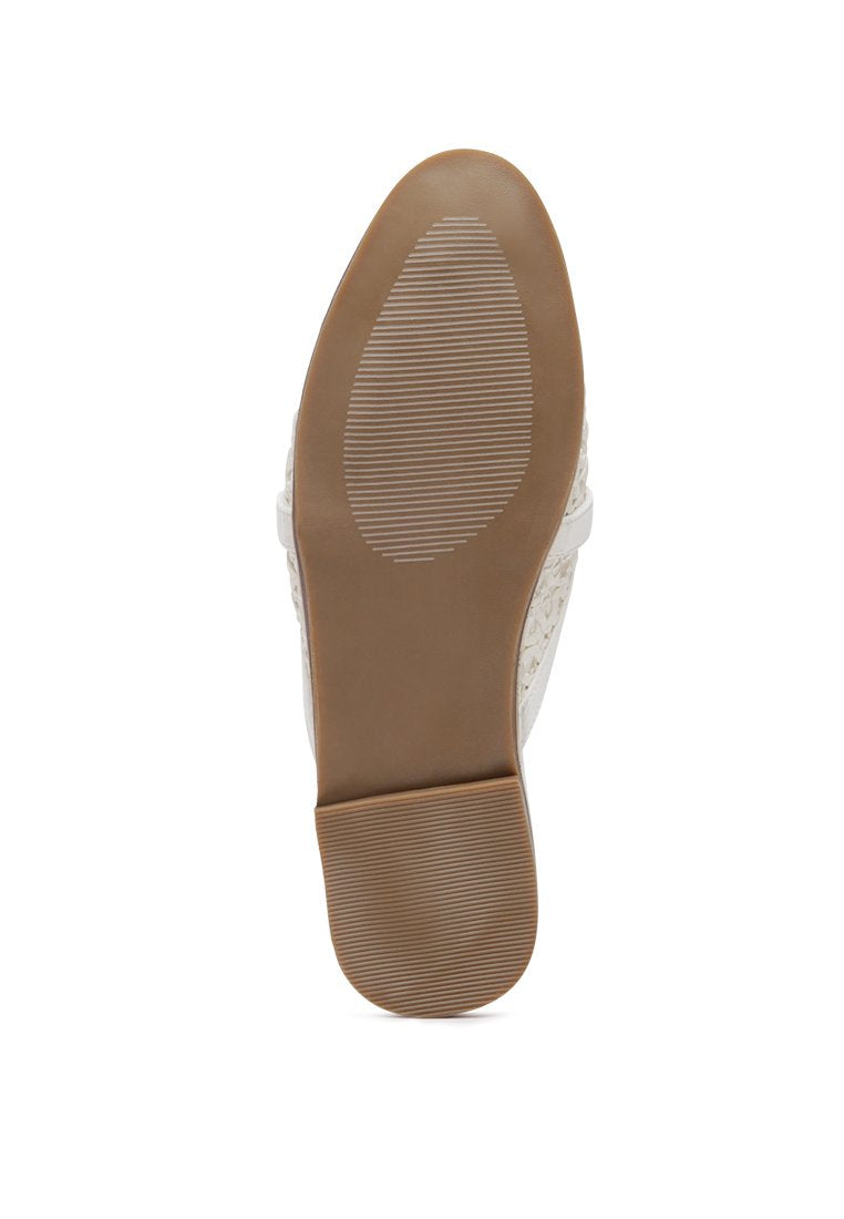 Ophelia Lattice Edge Woven Flat Mules featuring a decorative strap and round toe design, perfect for casual wear.