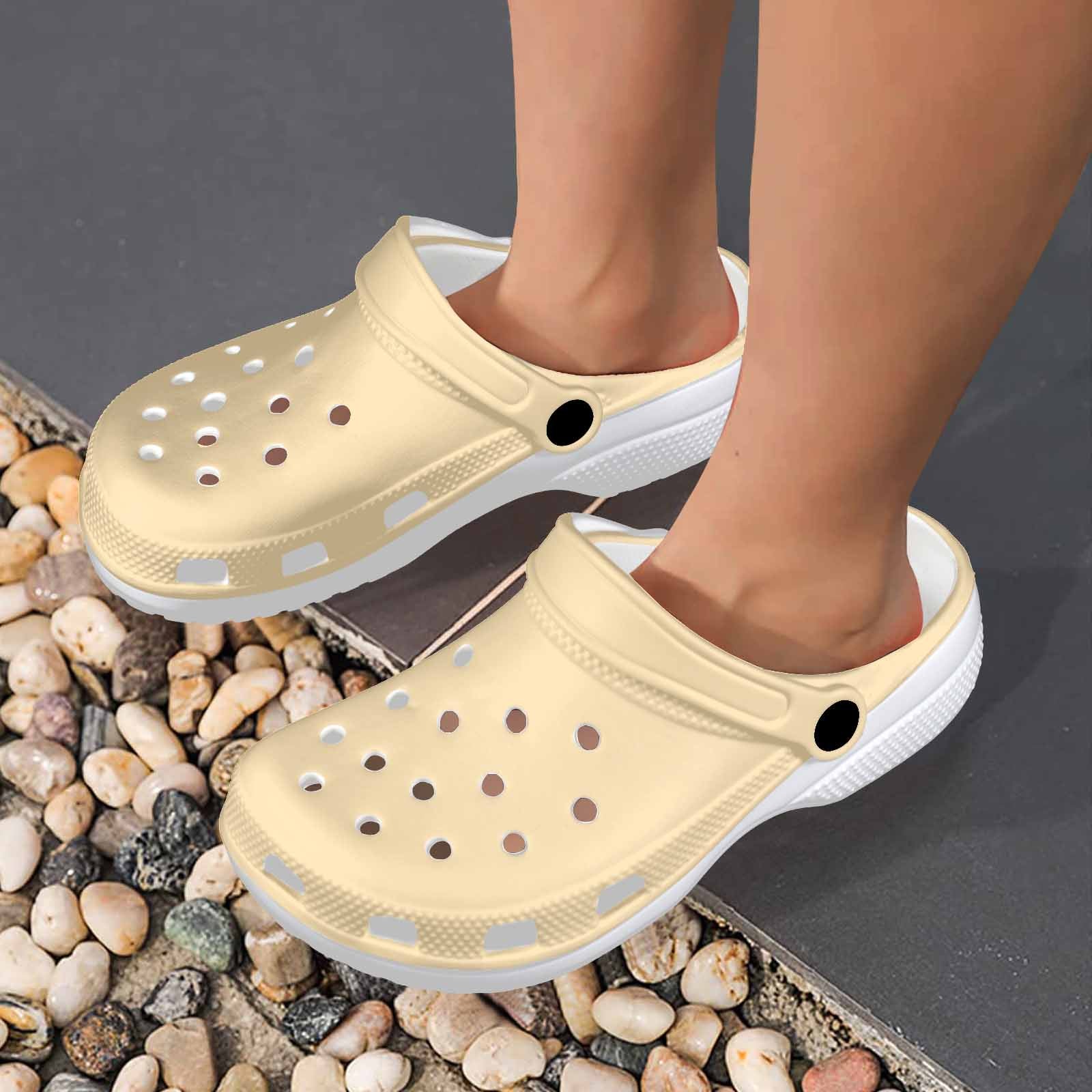 A pair of Peach Adult Clogs showcasing their lightweight design and ventilation ports, perfect for casual wear.