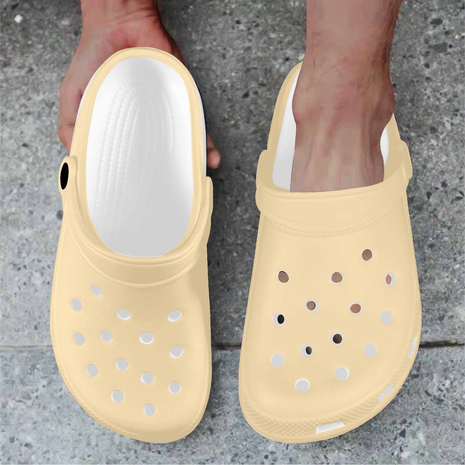 A pair of Peach Adult Clogs showcasing their lightweight design and ventilation ports, perfect for casual wear.