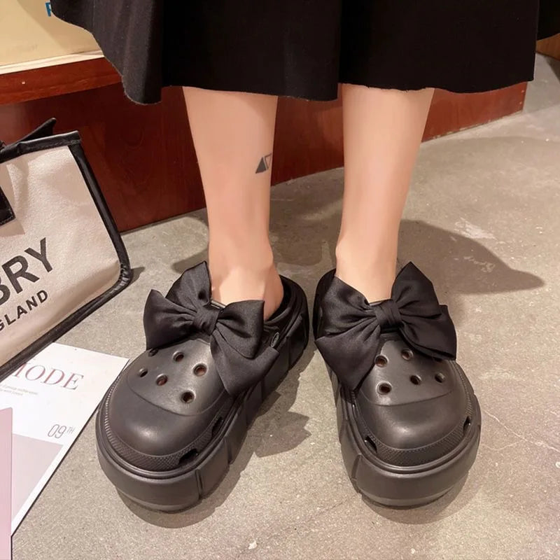 A pair of stylish Sexikinis Platform Slippers in green, black, and white, perfect for summer beach outings.