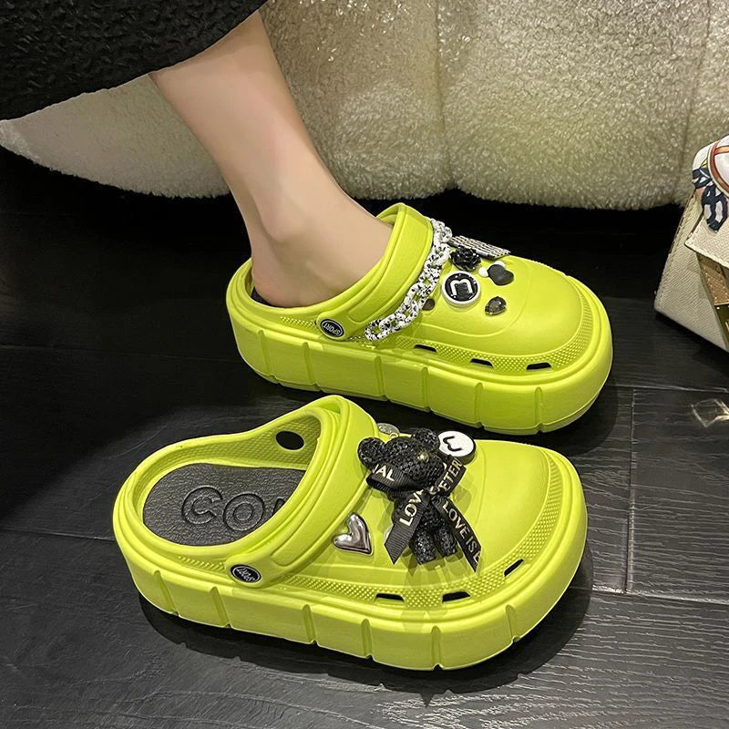 A pair of stylish Sexikinis Platform Slippers in green, black, and white, perfect for summer beach outings.