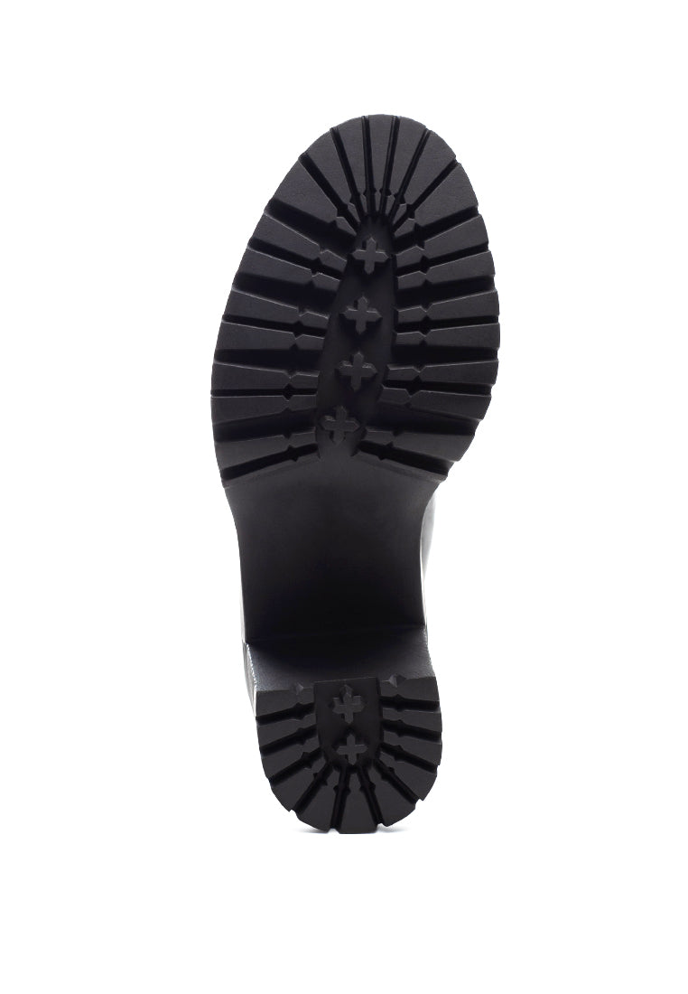 Sachs Block Heeled Chunky Loafers in patent faux leather with metal chain detail, showcasing a stylish and elegant design.