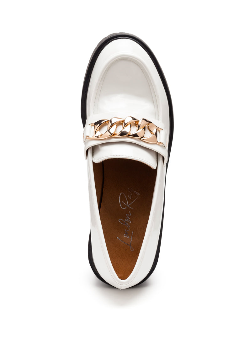 Sachs Block Heeled Chunky Loafers in patent faux leather with metal chain detail, showcasing a stylish and elegant design.