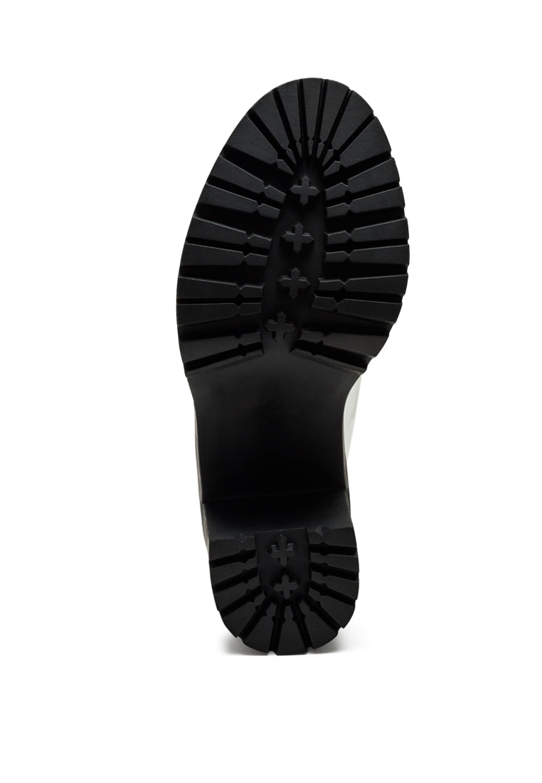 Sachs Block Heeled Chunky Loafers in patent faux leather with metal chain detail, showcasing a stylish and elegant design.