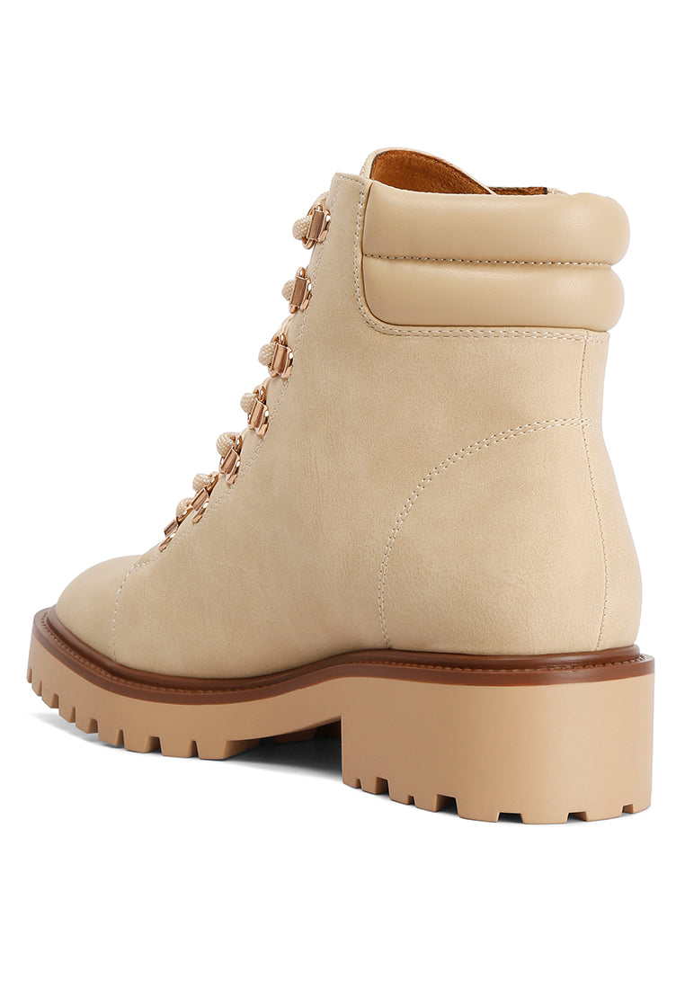 Shirly Quilt Collared Ankle Boots in beige with dark brown rim and metallic eyelets, showcasing a stylish design.