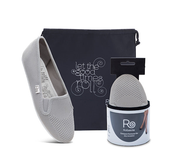 A pair of Storm fold-up trainers in a neutral color, displayed with a stylish carry bag, showcasing their lightweight and compact design.