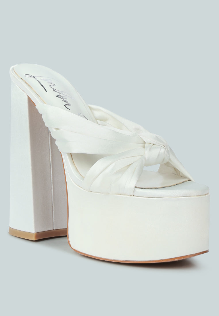 A pair of elegant Strobing Knotted Chunky Platform Heels featuring a satin knotted strap and chunky platform design, perfect for special occasions.