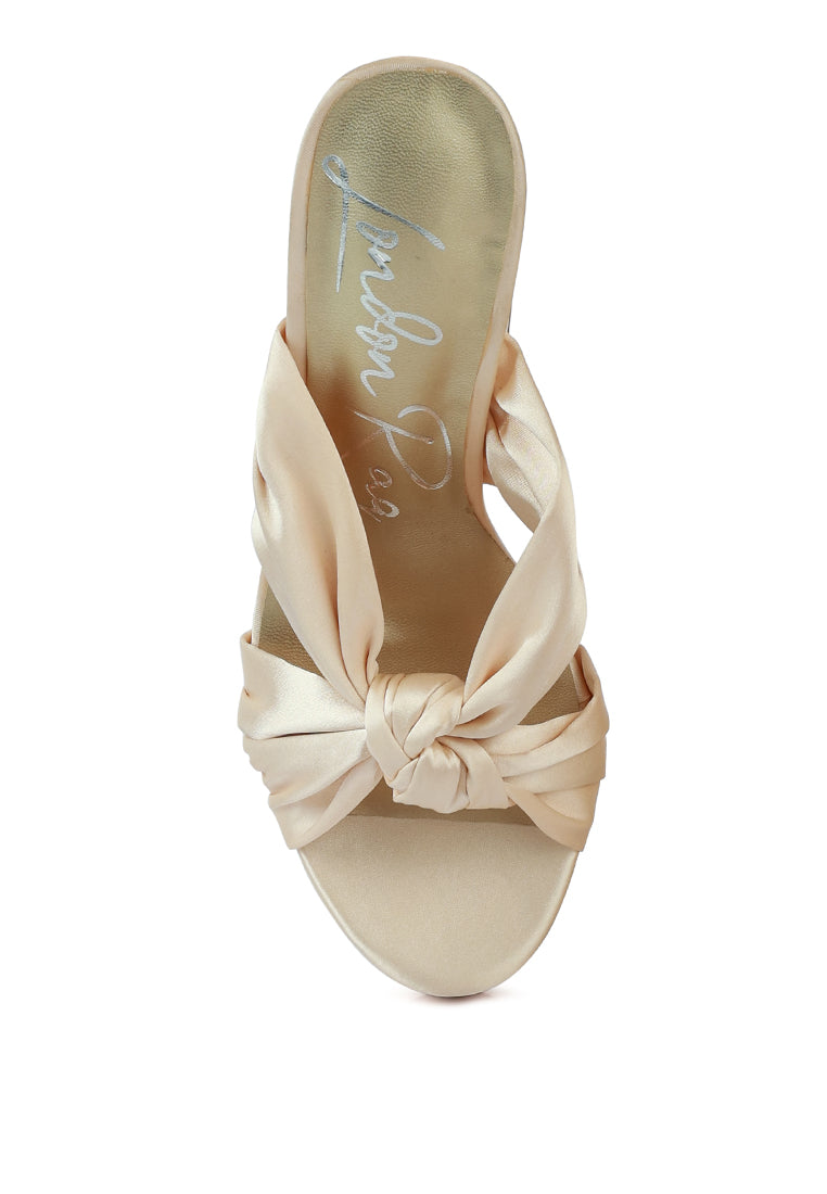 A pair of elegant Strobing Knotted Chunky Platform Heels featuring a satin knotted strap and chunky platform design, perfect for special occasions.