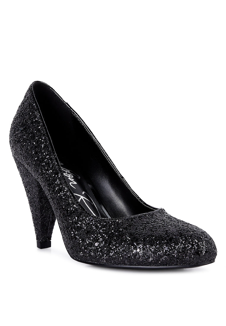 A pair of Sugar Plum Glitter Conical Heel Pumps showcasing a sparkling glitter exterior, conical heels, and a closed toe design, perfect for evening wear.